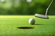 © Paitoon - Close-up golf ball after putting to the golf hole.