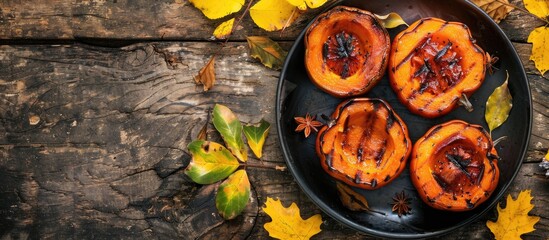 Poster - Traditional fall treat of grilled pumpkin served warm as dessert on a rustic table with yellow leaves and viburnum Top view with copy space image ideal for Halloween