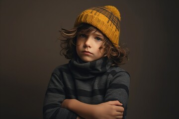 Sticker - A portrait of a little boy in a knitted hat and scarf.