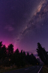 Wall Mural - Milky way and Aurora australis over the forest on the road in rural scene at New Zealand