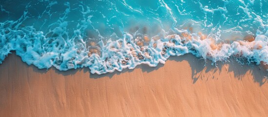Poster - Sunny tropical beach scene with a gentle sea wave rolling on the sand and plenty of copy space for adding text or images in the top down view