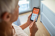 © Marko Geber - Rear view of a middle aged woman tracking workout time on smartphone