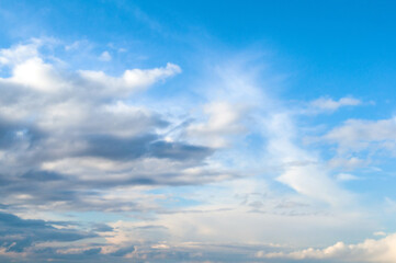 Wall Mural - blue sky landscape with dramatic colorful clouds and soft sunlight