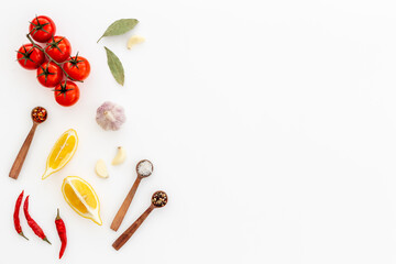 Wall Mural - Cooking concept with tomatoes and chili peppers, vegetables spices on the kitchen desk top