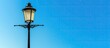 © vxnaghiyev - A vintage street lamp with a beautiful antique design stands out against a clear blue sky in the background perfect for adding text or images in the copy space image