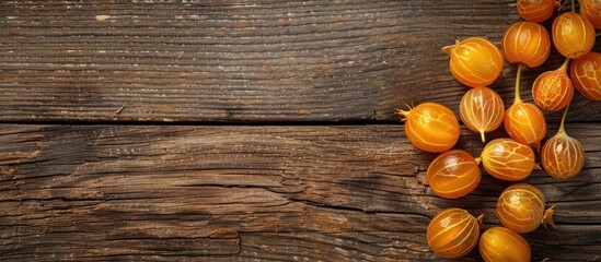 Poster - Overhead shot of cape gooseberries on a wooden surface with space for additional images