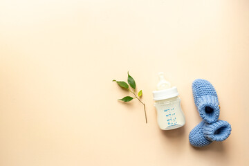 Wall Mural - Kids flat lay with baby shoes and milk in bottle, top view