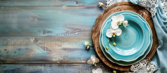 Leinwandbilder - Rustic retro kitchen table setting with old wooden board blue plate white orchid and lace towel under natural light and shade creating a nice vintage backdrop with copy space image