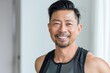 © CogniLens - Portrait of a grinning asian man in his 40s dressed in a breathable mesh vest over minimalist or empty room background