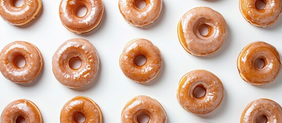 Fototapete - Flat lay image of delectable glazed donuts on a white background with room for text. with copy space image. Place for adding text or design