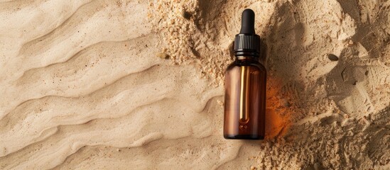 Poster - Beauty cosmetic face serum in a brown glass bottle with a pipette placed on a sandy natural background effective for hydrating the skin showcasing a copy space image
