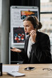 © LIGHTFIELD STUDIOS - Woman in business suit having a stressed phone conversation.