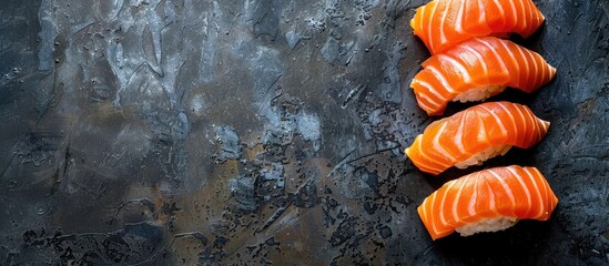 Wall Mural - Sliced salmon sushi nigiri on a dark backdrop with copy space image