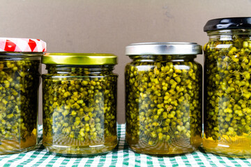 Four jars of pickled wild garlic seed capers.