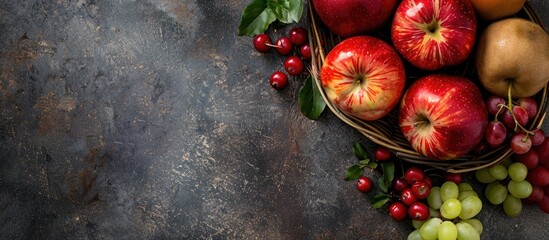 Wall Mural - organic fruits displayed on a stone table with a basket of ripe apples top view with copy space imag