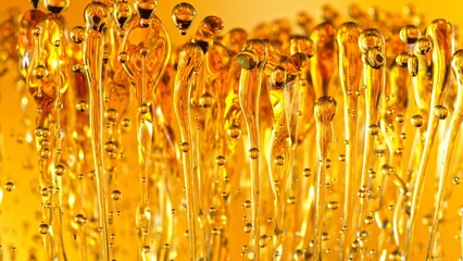 Canvas Print - Freeze Motion Shot of Splashing Oil on Golden Background