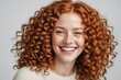 © ThomasLENNE - Portrait of beautiful cheerful redhead girl with flying curly hair smiling laughing looking at camera over white background.