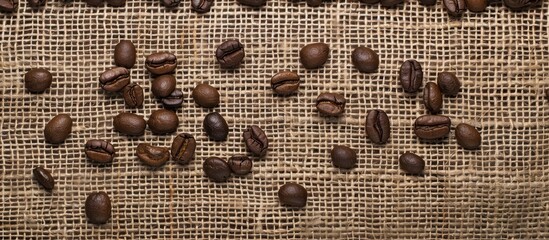 Canvas Print - Coffee beans displayed on a burlap backdrop with a clear area above and below for text or other elements in a copy space image