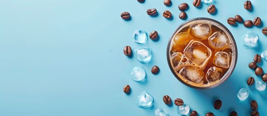 Canvas Print - Refreshing iced coffee with coffee beans and ice cubes on a blue backdrop for a cool summer beverage with copy space image