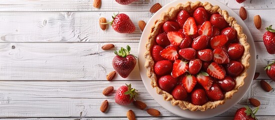 Poster - A homemade strawberry and almond tart placed on a white wooden surface with a flat lay composition leaving room for additional elements in the image