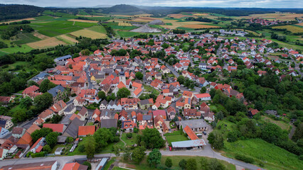 Wall Mural - Aerial view of the old town of  Markt Einersheim  in Germany, on a cloudy day in late spring.