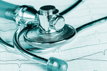 Wall Mural - Close-up of a stethoscope on an electrocardiogram graph. Medical healthcare concept