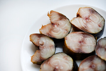 sliced smoked scomber on a white plate. fish appetizer.