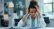 © BOTAHRY DEX - Headache, doctor or woman with stress or documents in hospital clinic overwhelmed by emergency. Depression, sick or tired healthcare worker in office frustrated by migraine pain, paperwork or burnout