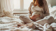 © VK Studio - A serene scene of a pregnant woman in a light-colored outfit, sitting cross-legged on a cozy bed, basking in the natural light from a nearby window.