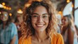 © YURY YUTY - A woman with glasses smiling joyfully, her friends laughing in the background.