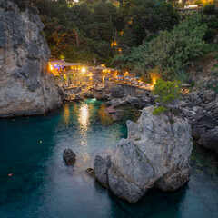 Wall Mural - Beautiful seascape at Paleokastritsa , La grotta beach, a small bay with emerald green water in corfu island,Greece , Aerial drone view by night