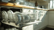 © Daniel - A dishwasher filled with white dishes in a kitchen.