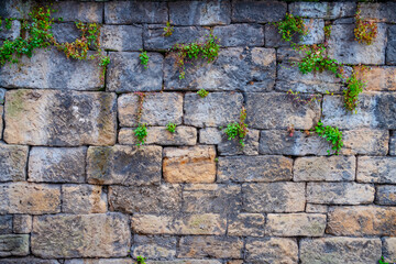 Wall Mural - antique stone background. old wall made of rectangular stoneseveral shades of brown and gray.