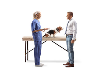 Wall Mural - Female veterinarian talking to a man with a basset hound dog