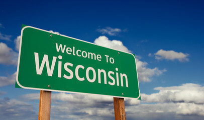 Wall Mural - Welcome To Wisconsin Green Road Sign Over Blue Sky with Some Clouds.