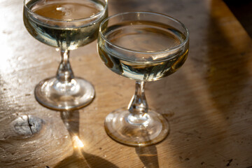 Wall Mural - Sparkling wine, cava or champagne in two coupe glasses on wooden table, French Riviera is summer, France