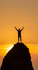 Canvas Print - A man is standing on a rock with his arms raised in the air