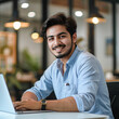 © Aqsapics - young handsome indian man using laptop and smiling