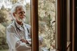 © senyumanmu - Happy senior doctor looking outside a window