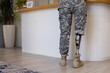 © Wavebreak Media - Military soldier person with prosthetic leg standing at counter in prosthetic clinic, copy space