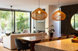 © Wavebreak Media - Modern dining area with wooden table and wicker pendant lights in cozy home, copy space