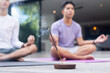 © Wavebreak Media - Meditating on yoga mats, male gay couple practicing mindfulness with incense burning, copy space