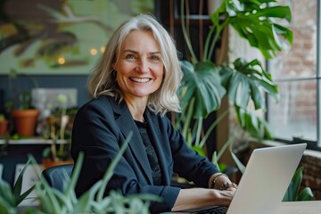 Wall Mural - Business woman using laptop computer in office. Happy middle aged woman, entrepreneur, small business owner working online - generative ai