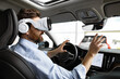 © sofiko14 - Man interacts with virtual reality headset while sitting inside modern vehicle, showcasing advanced automotive technology. Integration of VR in driving experience highlights innovation in cars.