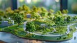 © BMMP Studio - Close-up of a model green park landscape with walking trails and environmental features.