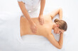 © Acronym - Young woman getting massaging treatment over white. Spa, healthcare and recreation concept.