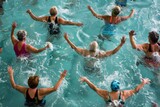 A group of active seniors participate in a lively water aerobics class, performing synchronized movements in an indoor swimming pool