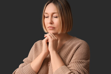 Wall Mural - Adult woman praying on black background