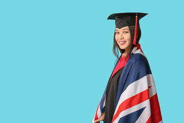 Canvas Print - Young female graduate with flag of Great Britain on blue background