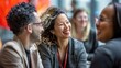 © nicole - Dynamic Team Spirit: Diverse Group of Professionals Engaging in Energetic Conversation, Smiling and Laughing in a Modern Office Environment. Highlighting Collaboration Across Ethnicities and Genders.